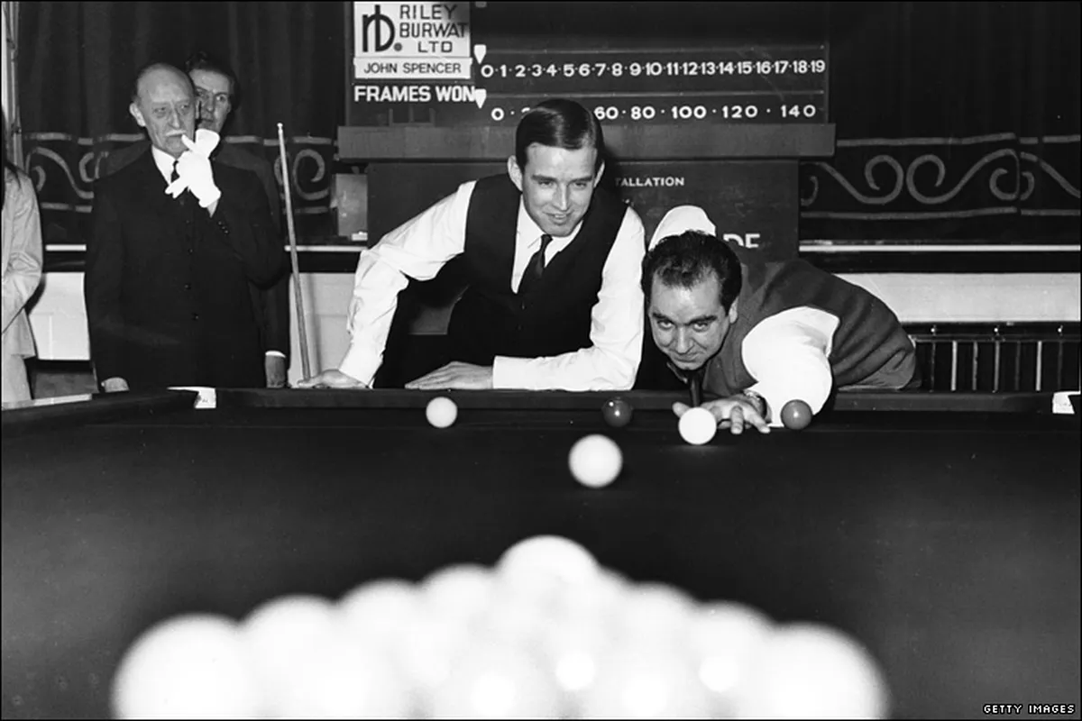Gary Owen of Tumble at the snooker table with Ray Reardon cueing